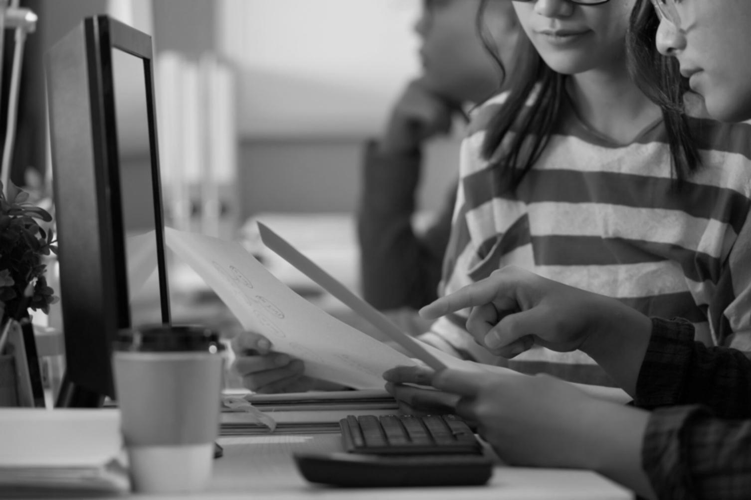 Investment theory education materials spread across a wooden desk